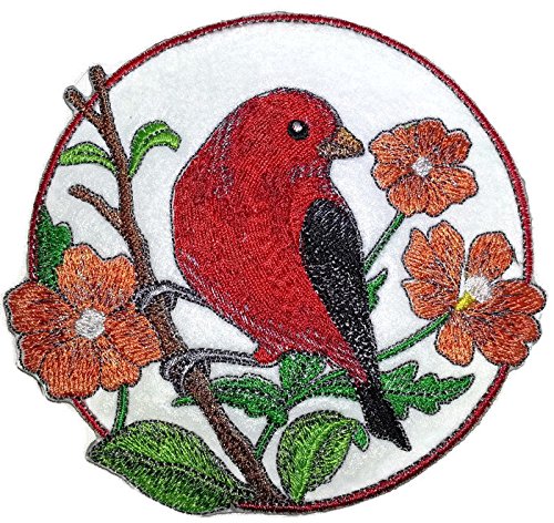Embroidered patch of a red bird on a branch with flowers on a white background