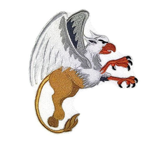 Embroidered patch of a fantasy creature with wings and a tail on a white background