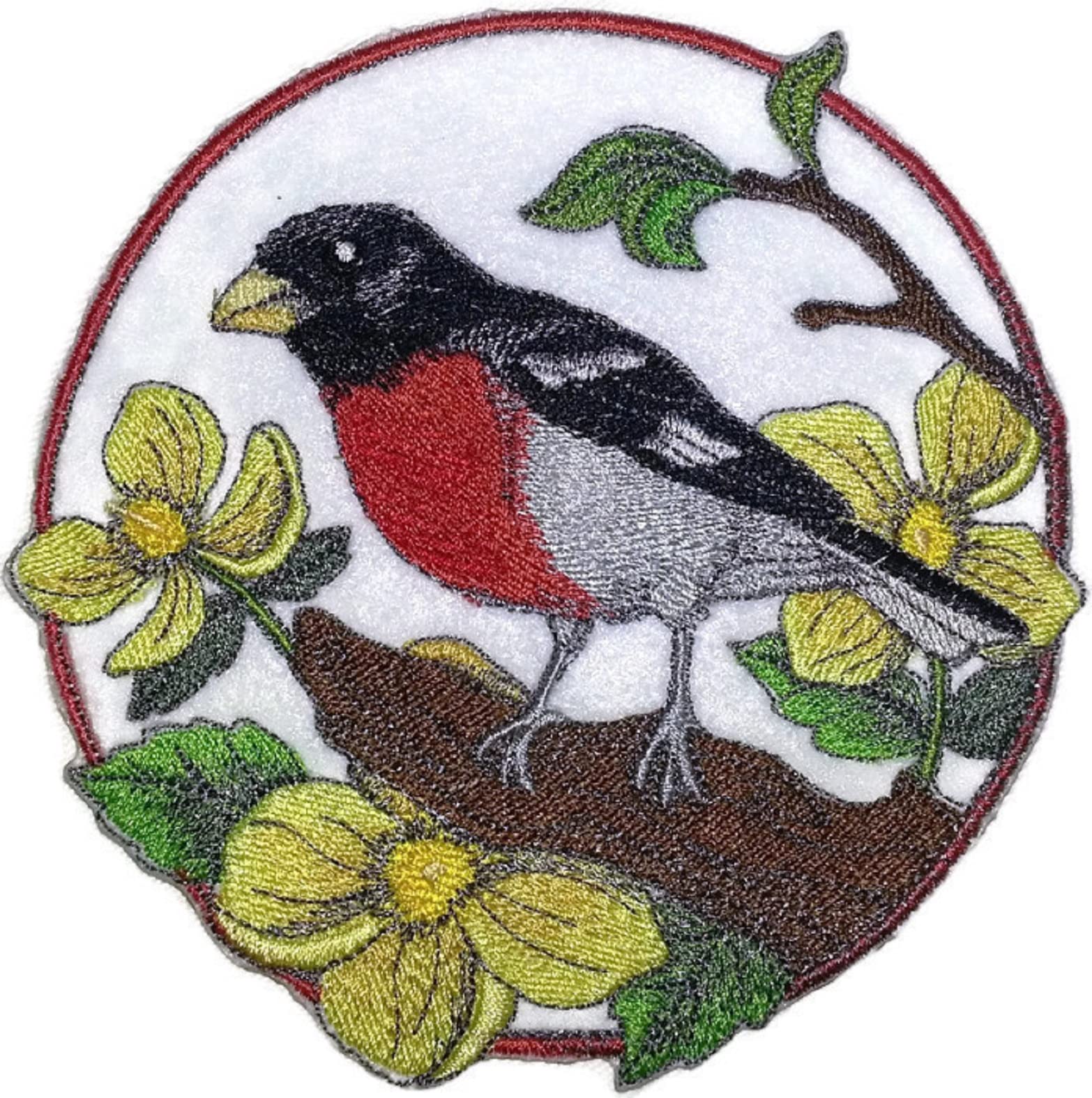 Embroidered patch of a bird on a branch with flowers