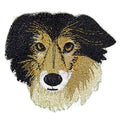 Embroidered patch of a dog's face with black, brown, and beige colors on a white background.