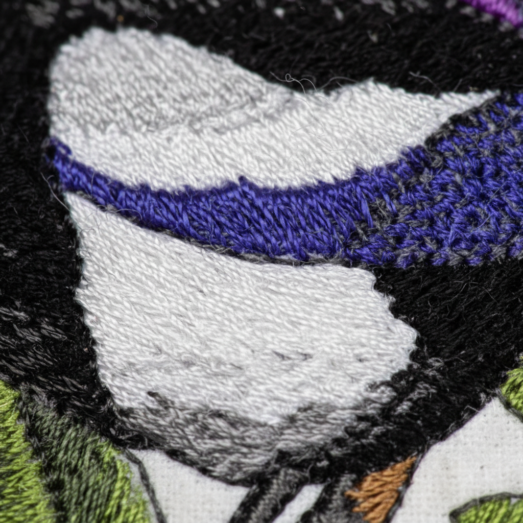 Extreme macro close-up of black and white embroidery stitching detail